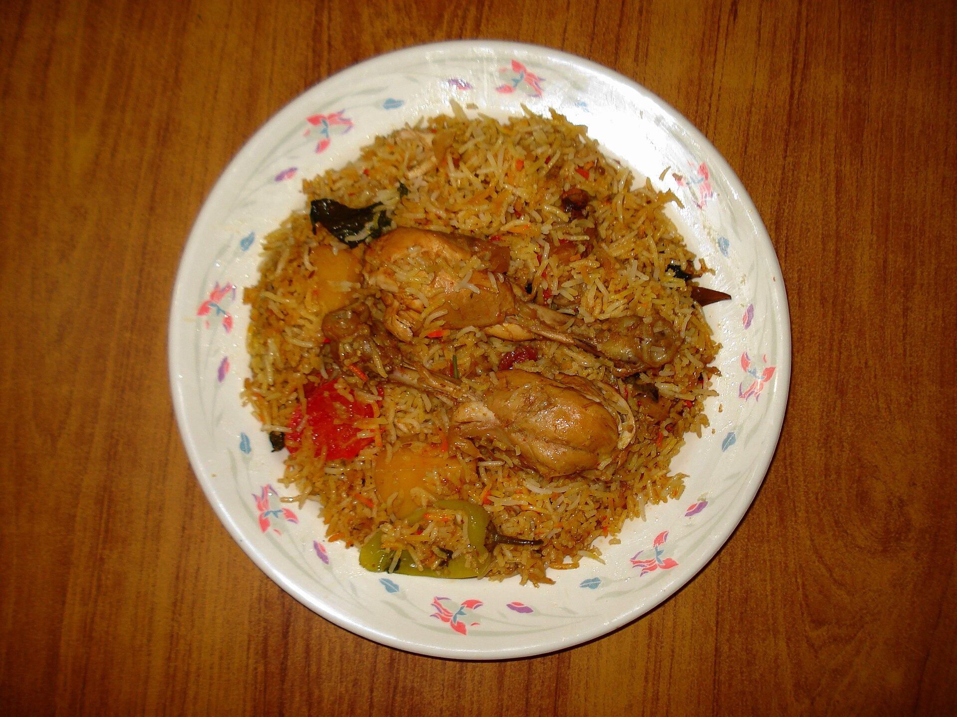A plated rice dish with spices, used as thematic imagery for celebratory Pakistani-American food rather than a specific Thanksgiving recipe