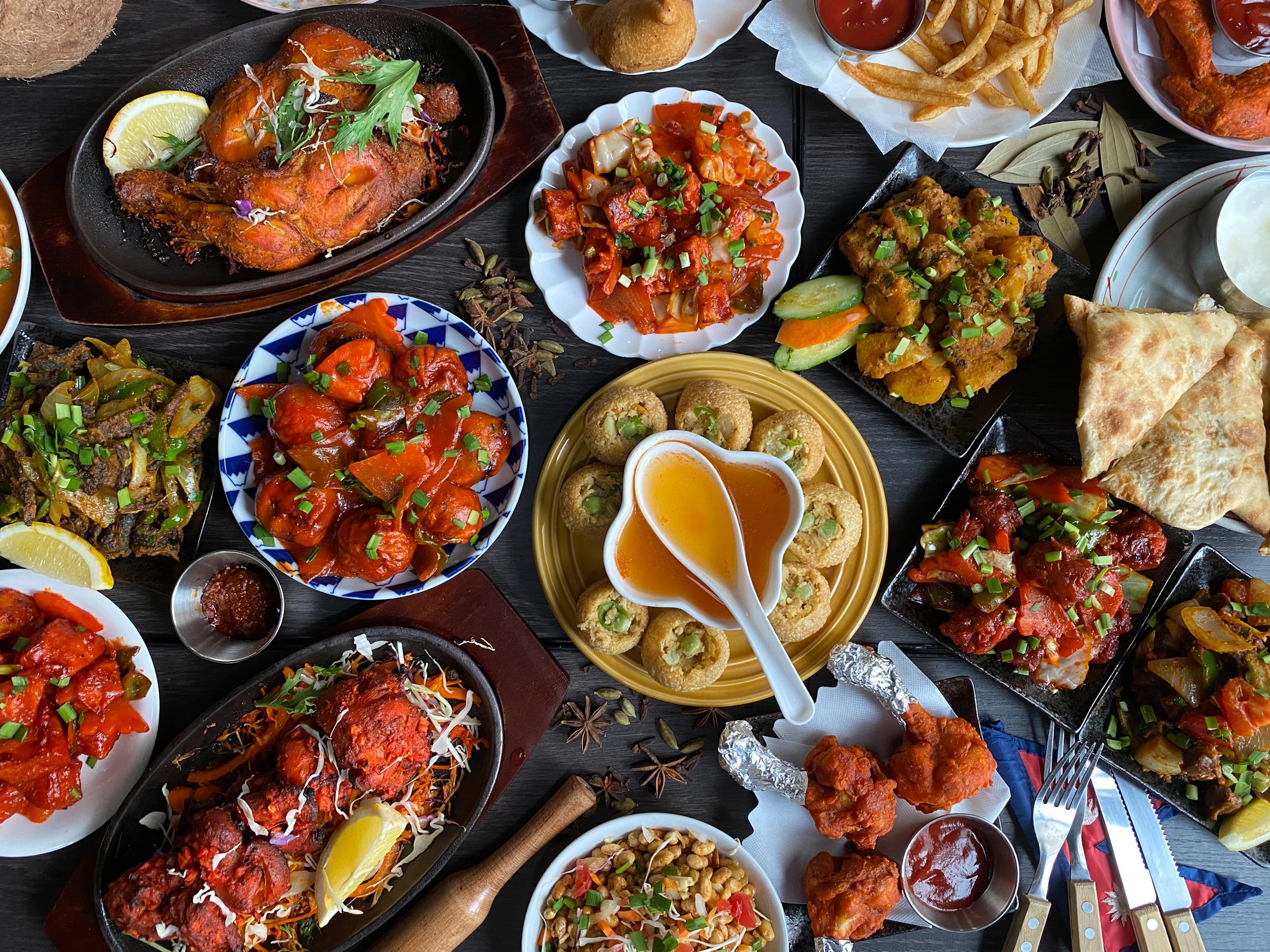 A table filled with different South Asian dishes